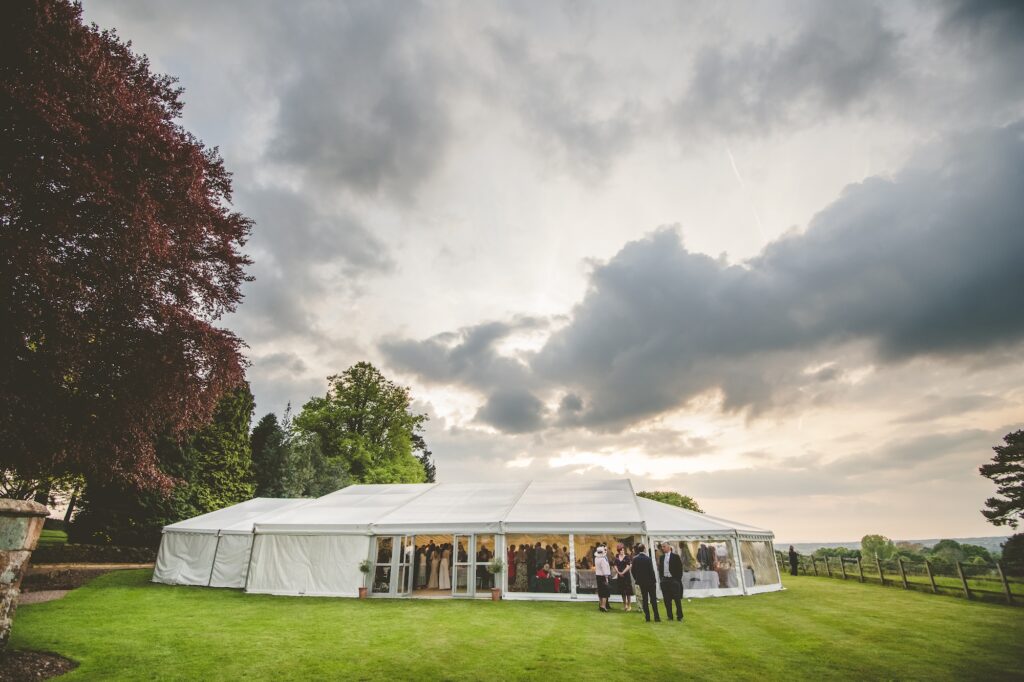 Bespoke wedding marquee on The Citadel's manicured wedding lawn beneath dramatic evening skies in North Shropshire
